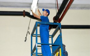 commercial electrical contractors doing lighting work on a cherry picker